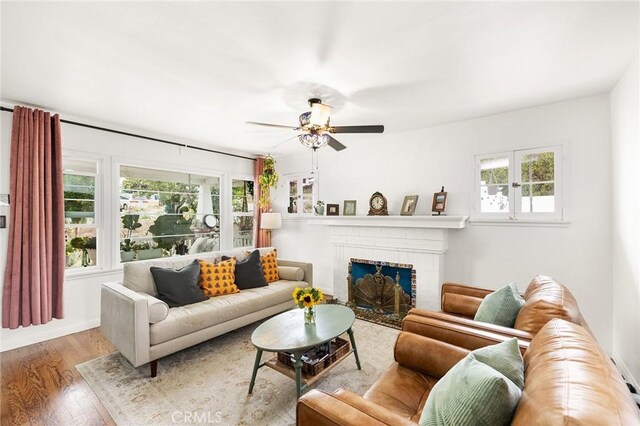206 S Wisconsin St, Fallbrook, CA 92028 - living area featuring wood finished floors, ceiling fan, and a brick fireplace