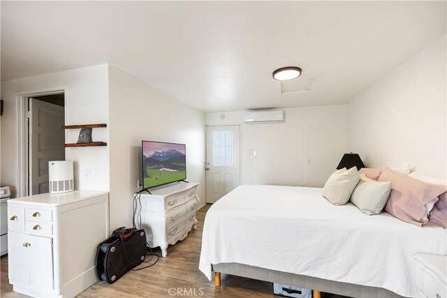 206 S Wisconsin St, Fallbrook, CA 92028 - bedroom featuring an AC wall unit and light wood-type flooring
