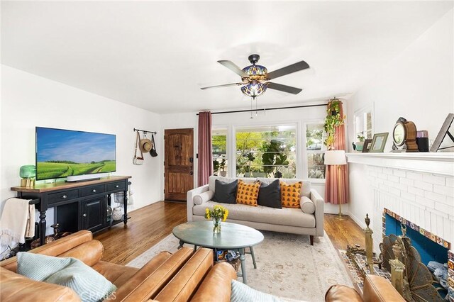 206 S Wisconsin St, Fallbrook, CA 92028 - living room with ceiling fan, wood finished floors, and a brick fireplace