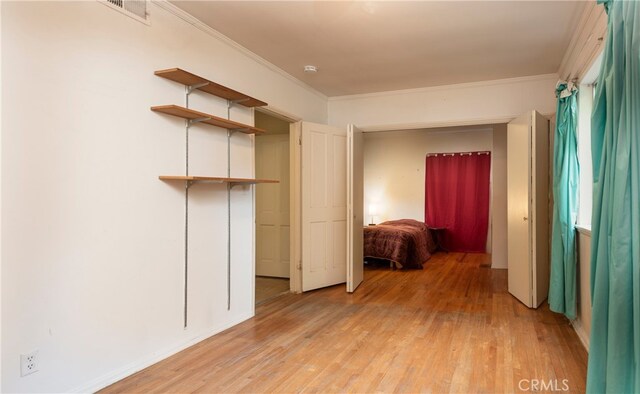 1731 Roscomare Rd, Los Angeles, CA 90077 - unfurnished bedroom with light wood finished floors and ornamental molding