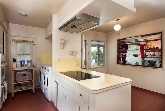 1731 Roscomare Rd, Los Angeles, CA 90077 - kitchen with washer and dryer, black electric stovetop, dark tile patterned flooring, and a peninsula