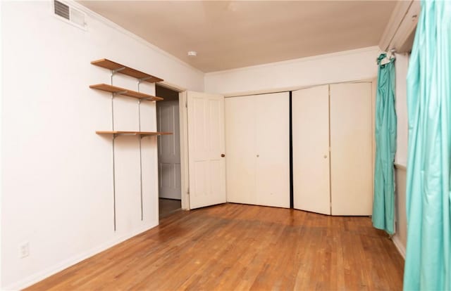 1731 Roscomare Rd, Los Angeles, CA 90077 - unfurnished bedroom featuring light wood-style flooring, ornamental molding, baseboards, and a closet