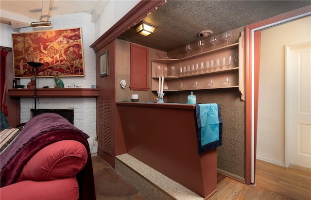 1731 Roscomare Rd, Los Angeles, CA 90077 - bar featuring wood finished floors, a brick fireplace, and baseboards
