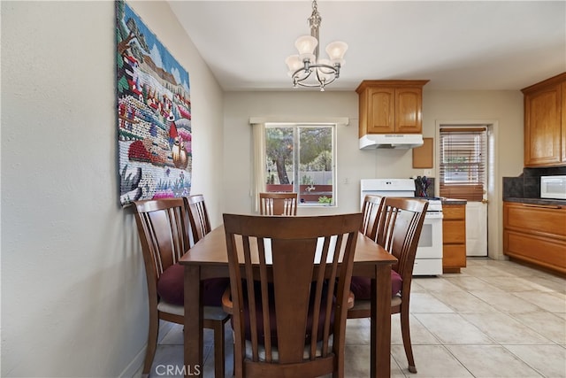 56287 Navajo Trl, Yucca Valley, CA 92284 - dining area featuring a chandelier and light tile patterned floors