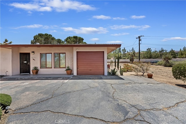 56287 Navajo Trl, Yucca Valley, CA 92284 - garage featuring asphalt driveway