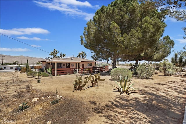 56287 Navajo Trl, Yucca Valley, CA 92284 - rear view of house with a deck with mountain view