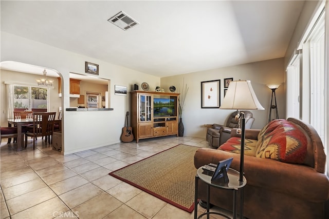 56287 Navajo Trl, Yucca Valley, CA 92284 - living area with a chandelier, light tile patterned floors, and arched walkways