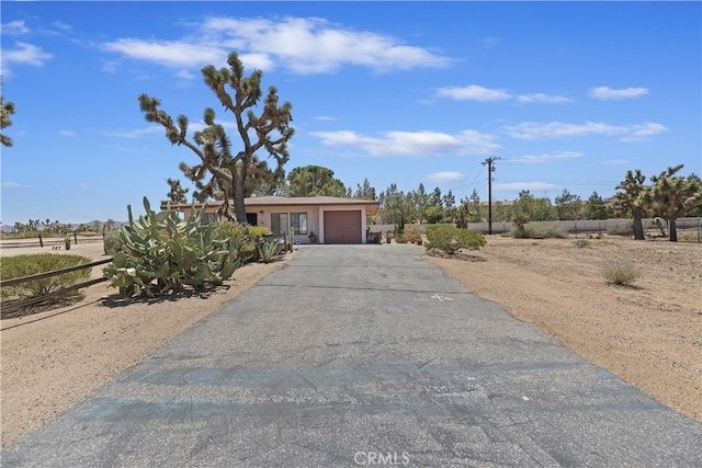 56287 Navajo Trl, Yucca Valley, CA 92284 - view of front of home with an attached garage and driveway