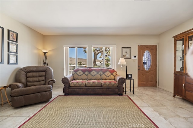 56287 Navajo Trl, Yucca Valley, CA 92284 - living room featuring light tile patterned floors and baseboards
