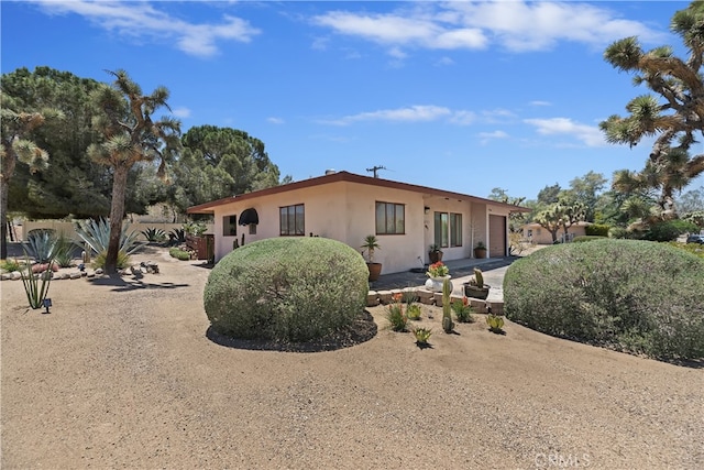 56287 Navajo Trl, Yucca Valley, CA 92284 - view of front of property with stucco siding and a garage