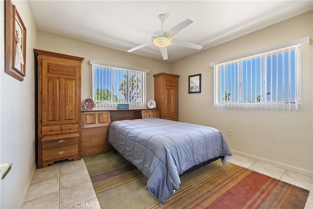 56287 Navajo Trl, Yucca Valley, CA 92284 - bedroom with light tile patterned floors, a ceiling fan, and baseboards