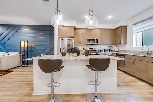 5261 Beachfront Cove St # 174, San Diego, CA 92154 - kitchen with appliances with stainless steel finishes, a sink, a kitchen bar, and a center island