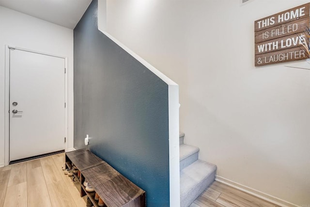 5261 Beachfront Cove St # 174, San Diego, CA 92154 - staircase featuring wood finished floors and baseboards