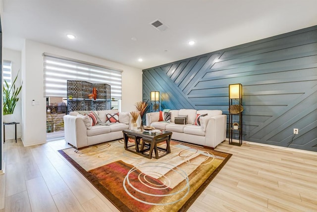 5261 Beachfront Cove St # 174, San Diego, CA 92154 - living room with wood finished floors, baseboards, recessed lighting, and an accent wall