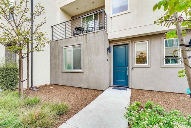 5261 Beachfront Cove St # 174, San Diego, CA 92154 - entrance to property featuring stucco siding and a balcony