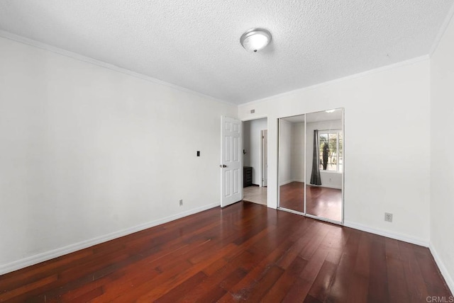 13808 Pomerado Rd, Poway, CA 92064 - unfurnished bedroom with wood-type flooring, crown molding, a closet, a textured ceiling, and baseboards