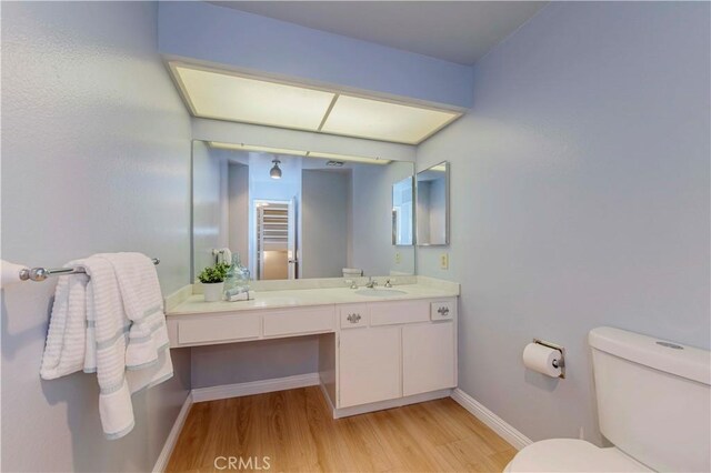 28012 Ridgeforest Ct, Rancho Palos Verdes, CA 90275 - bathroom with wood finished floors, baseboards, vanity, and toilet