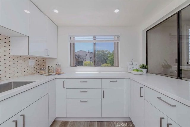 28012 Ridgeforest Ct, Rancho Palos Verdes, CA 90275 - kitchen with white cabinetry, light countertops, tasteful backsplash, recessed lighting, and light wood-style floors