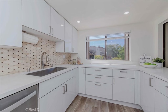 28012 Ridgeforest Ct, Rancho Palos Verdes, CA 90275 - kitchen featuring dishwasher, white cabinets, light countertops, tasteful backsplash, and light wood finished floors