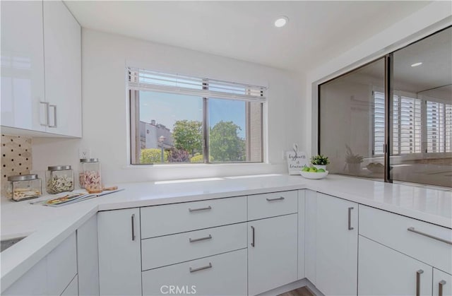 28012 Ridgeforest Ct, Rancho Palos Verdes, CA 90275 - kitchen with light countertops, white cabinets, recessed lighting, and tasteful backsplash