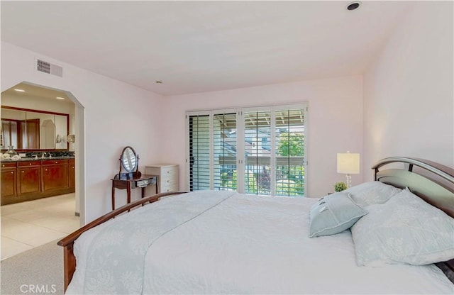 28012 Ridgeforest Ct, Rancho Palos Verdes, CA 90275 - bedroom featuring connected bathroom, arched walkways, light tile patterned floors, and recessed lighting
