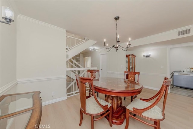 28012 Ridgeforest Ct, Rancho Palos Verdes, CA 90275 - dining area with light wood-style flooring, stairs, a chandelier, and ornamental molding