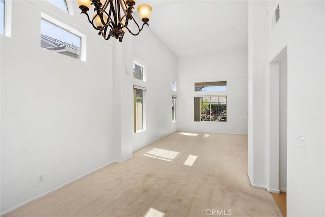 32147 Corte Florecita, Temecula, CA 92592 - unfurnished living room with a chandelier, a towering ceiling, and carpet flooring