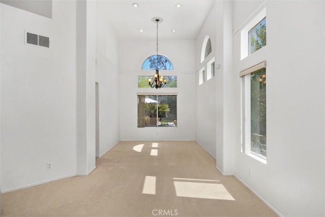 32147 Corte Florecita, Temecula, CA 92592 - empty room featuring a chandelier, a towering ceiling, carpet, recessed lighting, and baseboards