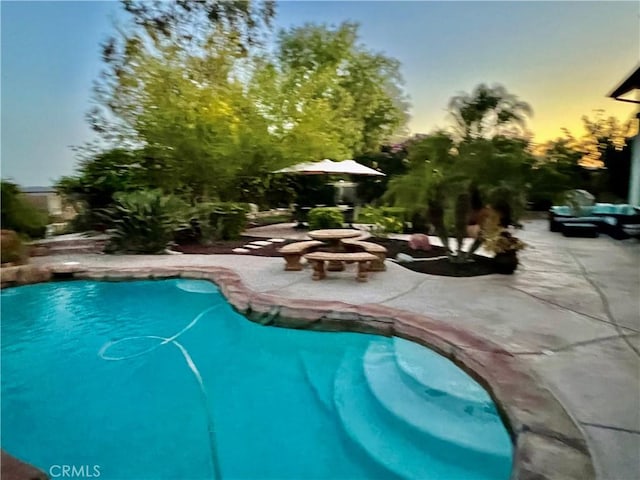 32147 Corte Florecita, Temecula, CA 92592 - pool at dusk featuring a patio and an outdoor pool