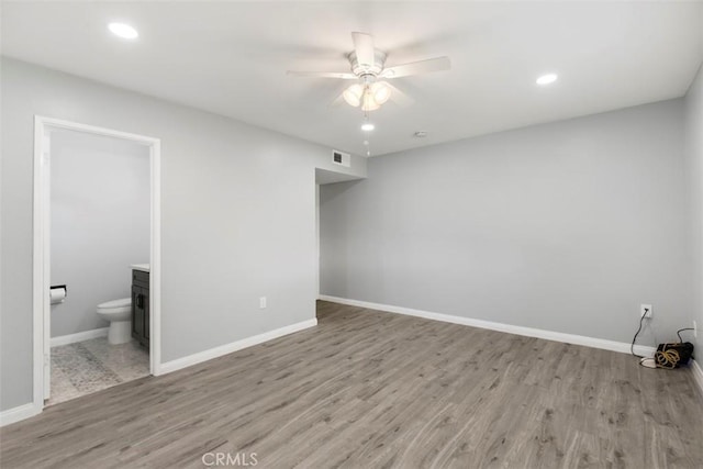 25781 Interlechen Dr, Menifee, CA 92586 - unfurnished bedroom with wood finished floors, baseboards, ensuite bath, recessed lighting, and ceiling fan