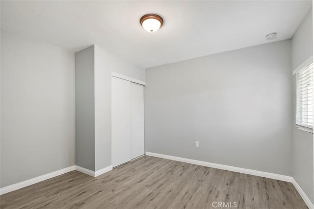 25781 Interlechen Dr, Menifee, CA 92586 - unfurnished bedroom with wood finished floors, a closet, and baseboards