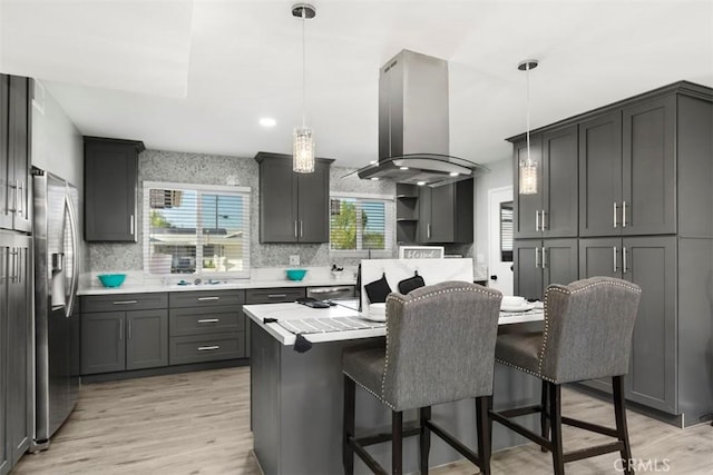 25781 Interlechen Dr, Menifee, CA 92586 - kitchen with a kitchen breakfast bar, tasteful backsplash, stainless steel refrigerator with ice dispenser, and light wood finished floors