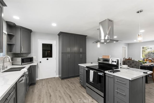 25781 Interlechen Dr, Menifee, CA 92586 - kitchen featuring appliances with stainless steel finishes, open shelves, island range hood, a sink, and light wood finished floors