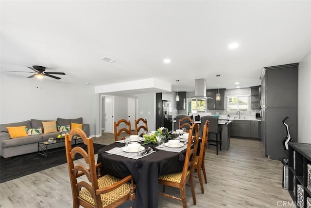 25781 Interlechen Dr, Menifee, CA 92586 - dining space featuring light wood finished floors, ceiling fan, and recessed lighting
