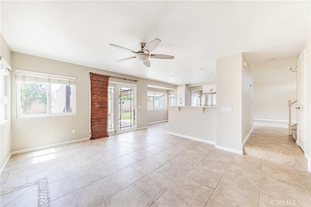 24701 New Haven Dr, Murrieta, CA 92562 - unfurnished living room featuring ceiling fan, baseboards, and light tile patterned floors