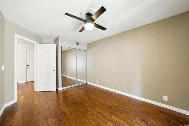 3078 Broadway Unit 210, San Diego, CA 92102 - unfurnished bedroom with dark wood-type flooring, baseboards, a closet, and a ceiling fan