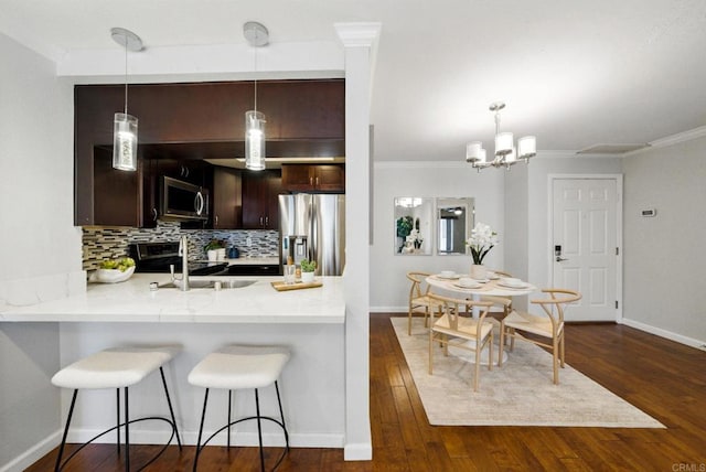 3078 Broadway Unit 210, San Diego, CA 92102 - kitchen featuring stainless steel appliances, light countertops, dark brown cabinets, backsplash, and a sink