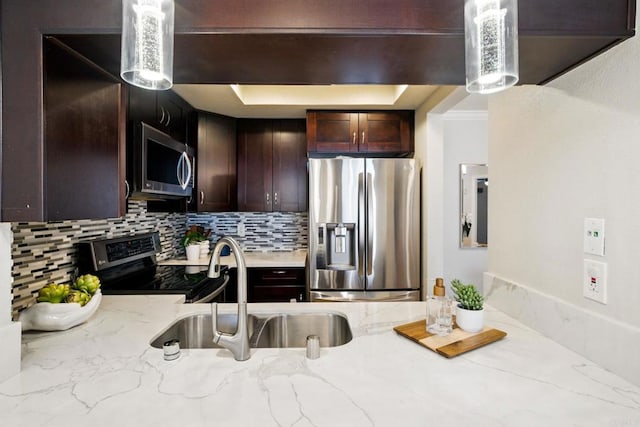 3078 Broadway Unit 210, San Diego, CA 92102 - kitchen with stainless steel appliances, a sink, backsplash, a tray ceiling, and light stone countertops