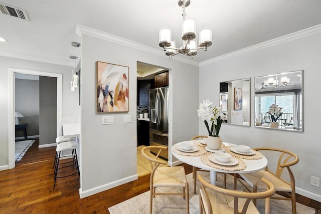 3078 Broadway Unit 210, San Diego, CA 92102 - dining area featuring a chandelier, crown molding, baseboards, and dark wood-style floors