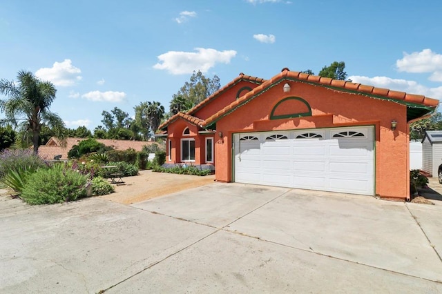 4294 Panorama Dr, La Mesa, CA 91941 - mediterranean / spanish-style house with concrete driveway, a garage, a tile roof, and stucco siding