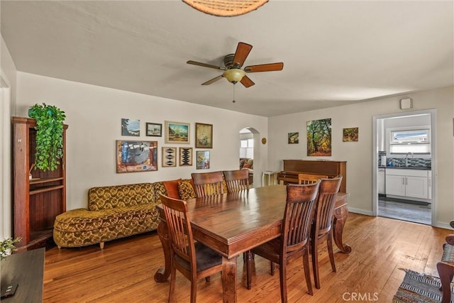 225 W 12th St, Chico, CA 95928 - dining room with arched walkways, ceiling fan, and light wood-type flooring