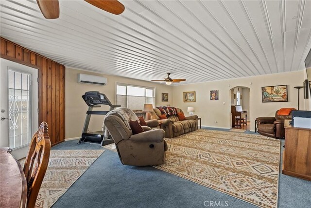 225 W 12th St, Chico, CA 95928 - carpeted living area with ceiling fan, a wall unit AC, arched walkways, and baseboards