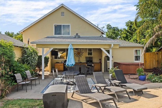 225 W 12th St, Chico, CA 95928 - rear view of house featuring a hot tub, a patio, stucco siding, and outdoor dining space
