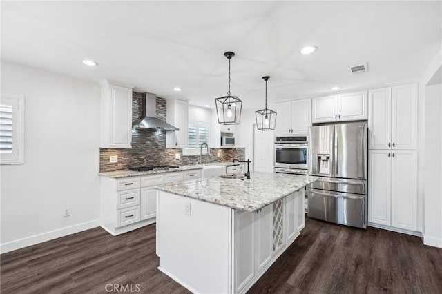 1762 Bern Dr, Corona, CA 92882 - kitchen with appliances with stainless steel finishes, wall chimney range hood, white cabinetry, dark wood-style flooring, and tasteful backsplash