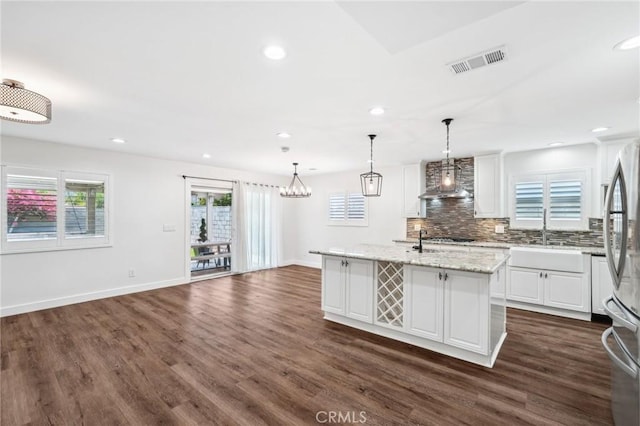 1762 Bern Dr, Corona, CA 92882 - kitchen featuring wall chimney range hood, dark wood-type flooring, a sink, tasteful backsplash, and white cabinets