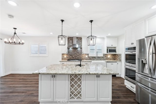 1762 Bern Dr, Corona, CA 92882 - kitchen featuring appliances with stainless steel finishes, wall chimney range hood, backsplash, baseboards, and a sink
