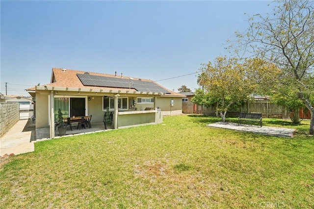 1762 Bern Dr, Corona, CA 92882 - back of house with a patio area, stucco siding, solar panels, and a shingled roof
