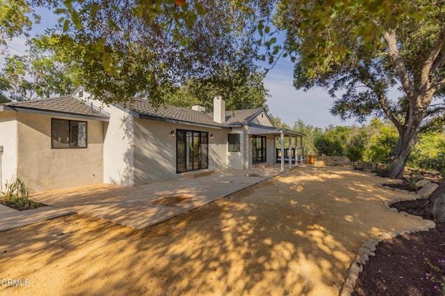 1068 Cuyama Rd, Ojai, CA 93023 - back of property featuring stucco siding, a patio, and a chimney