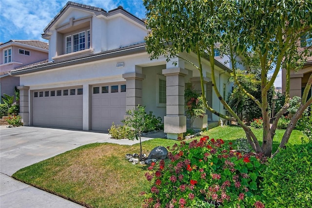 11884 Mariposa Bay Ln, Porter Ranch, CA 91326 - view of front facade with driveway, a garage, and stucco siding