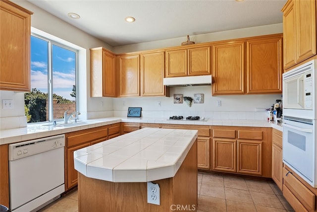 11884 Mariposa Bay Ln, Porter Ranch, CA 91326 - kitchen featuring white appliances, under cabinet range hood, a sink, tile counters, and recessed lighting